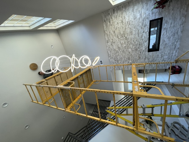 Pendant lighting installation in a tall residential entryway