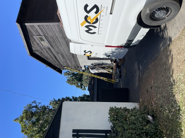 MCS Electric service van beside a residential property
