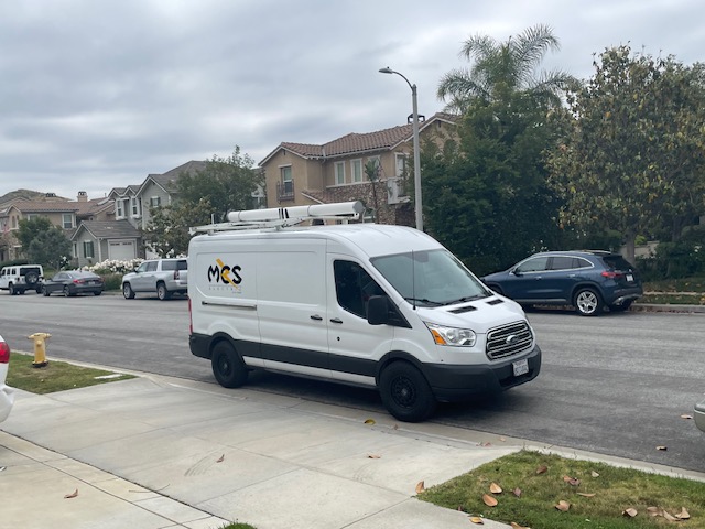 MCS Electric service van parked on a neighborhood street
