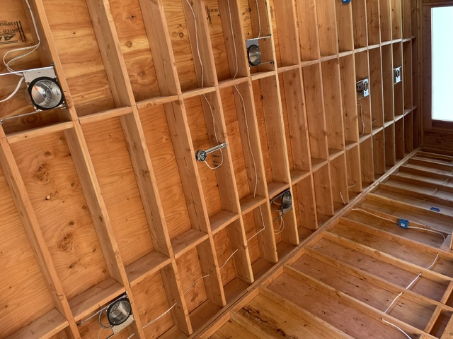 Ceiling electrical boxes and wiring installed between exposed joists
