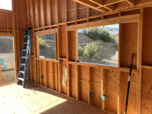 Electrical wiring and outlet locations along a framed window wall