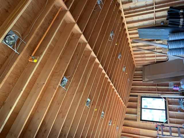 Recessed lighting rough-in along a framed ceiling