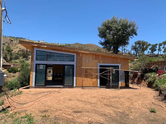 New construction exterior with a wide opening and work in progress