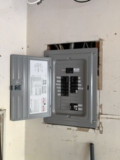 Open electrical subpanel with newly installed breakers