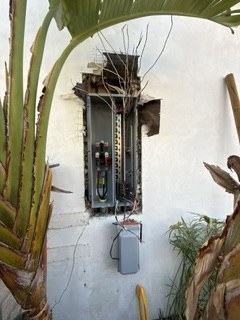 Exterior panel upgrade in progress beside landscaping