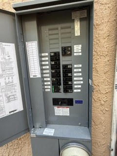 Close view of an open breaker panel and circuit directory