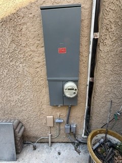 Closed exterior main panel and meter with connected conduits