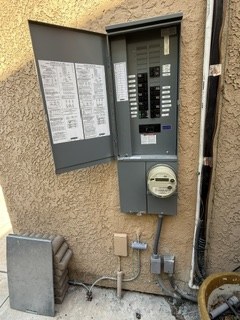 Open exterior main panel showing breaker layout and meter