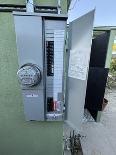 Close view of an exterior panel and electrical meter