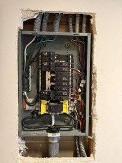 Electrical panel wiring visible during upgrade work