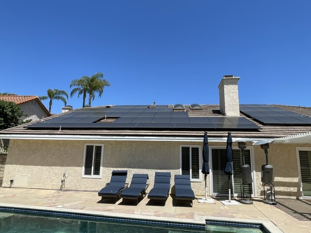 Residential rooftop solar panels viewed from the backyard