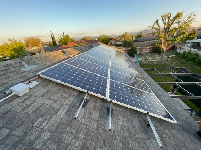 Solar panel installation along a sloped shingle roof
