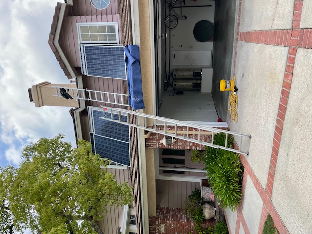 Residential solar installation in progress with roof access ladder
